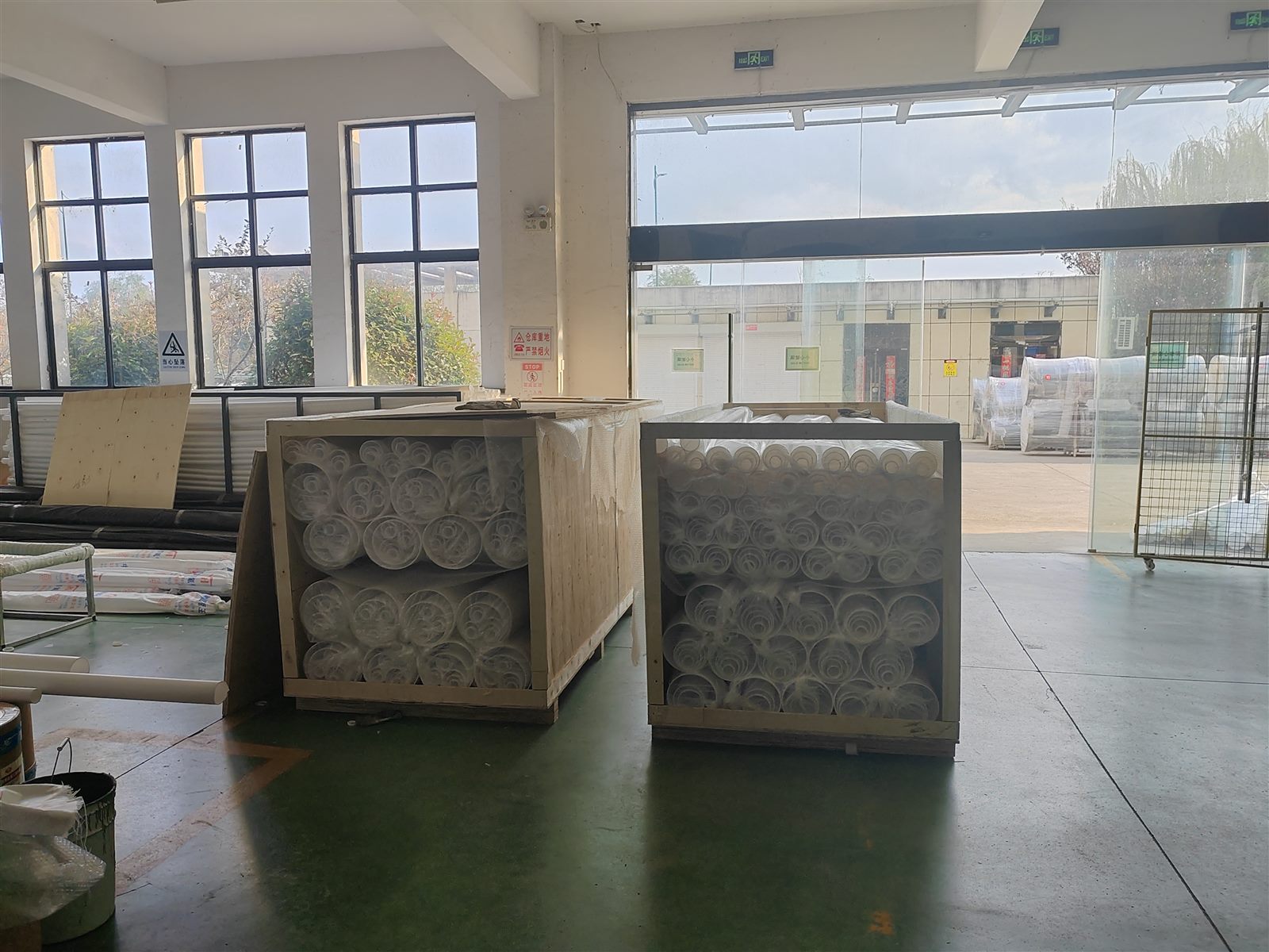 Coiled fluoropolymer products protected in wooden cases before shipment
